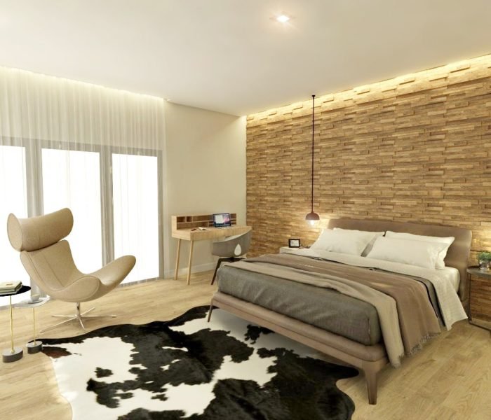 Descubre el dormitorio diseñado por Estudio Welfare en La Tahona, Canelones. Destacando un cabecero de madera y pisos claros, la moderna cama se complementa con una alfombra de cuero de vaca y una butaca Imola para relajarse junto al ventanal. Un pequeño escritorio nórdico y una TV en mueble flotante añaden funcionalidad sin sacrificar la ligereza del espacio. Disfruta de las vistas a los hermosos jardines desde el gran ventanal equinero.